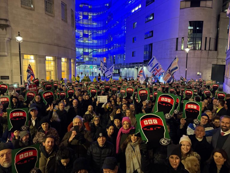 Crowd holds placards in protest outside the BBC