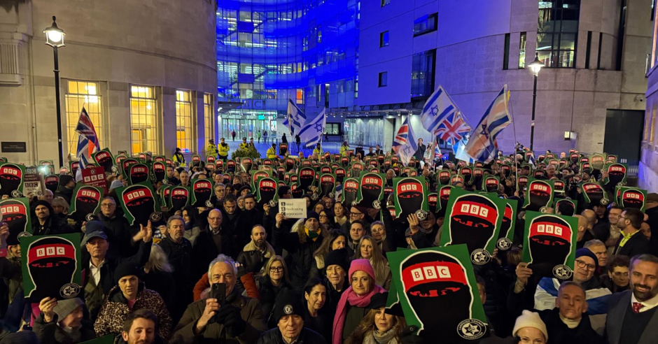 Crowd holds placards in protest outside the BBC